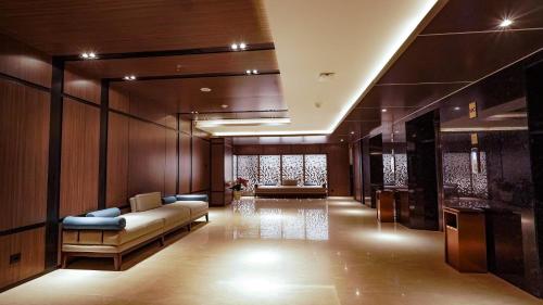 a living room with a couch and a table at FUGO Hotel Samarinda in Samarinda