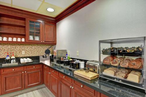 a kitchen with a counter with a display case of donuts at Homewood Suites by Hilton Reno in Reno