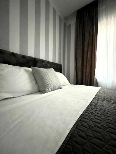 a bedroom with a white bed and a window at Vinceia in Smederevo