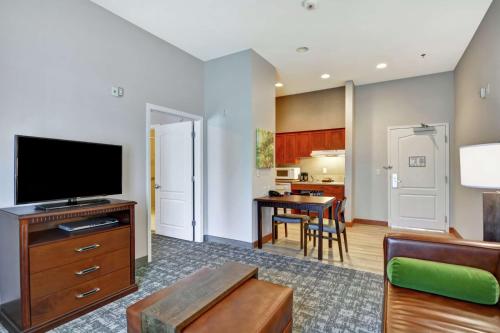 a living room with a television and a table at Homewood Suites by Hilton Reno in Reno