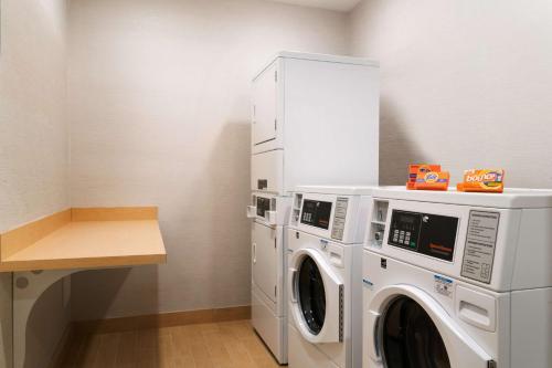 a laundry room with a washer and dryer at Home2 Suites by Hilton Roanoke in Roanoke