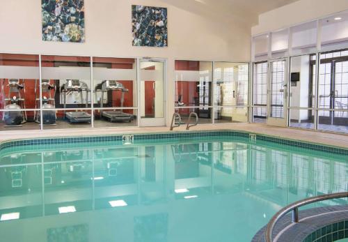 a swimming pool with blue water in a building at Hampton Inn & Suites Rochester/Victor in Victor