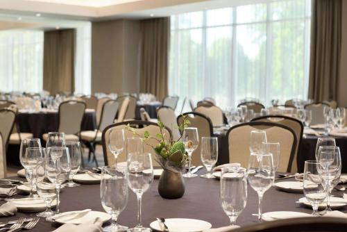 a conference room with tables and chairs with wine glasses at Hilton Garden Inn Rochester - University & Medical Center in Rochester