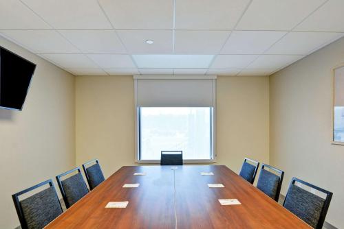 a conference room with a long table and chairs at Home2 Suites by Hilton Rochester Mayo Clinic Area in Rochester