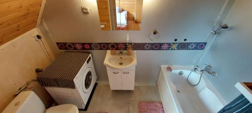 a bathroom with a toilet and a sink and a tub at 650m n.p.m. in Zawoja