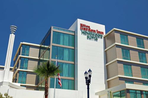 a building with a palm tree in front of it at Hilton Garden Inn San Diego Downtown/Bayside, CA in San Diego