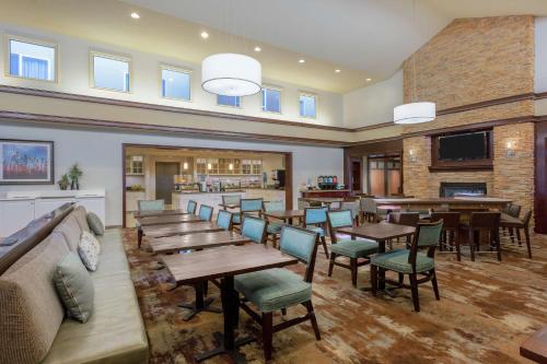 a restaurant with tables and chairs and a bar at Homewood Suites by Hilton Carlsbad-North San Diego County in Carlsbad
