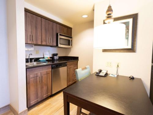 a small kitchen with a table and a sink at Homewood Suites by Hilton Carlsbad-North San Diego County in Carlsbad