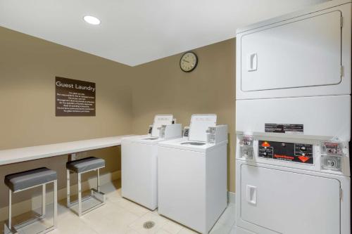 a kitchen with white appliances and a counter at Homewood Suites by Hilton Carlsbad-North San Diego County in Carlsbad