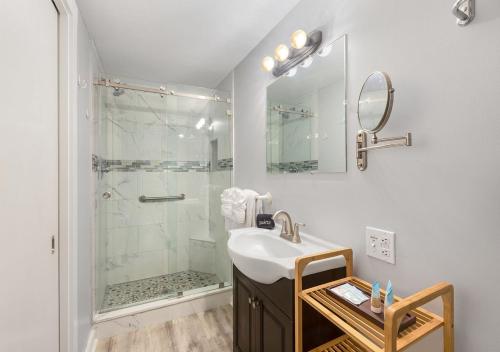 a bathroom with a sink and a shower at The Grand Guesthouse in Key West