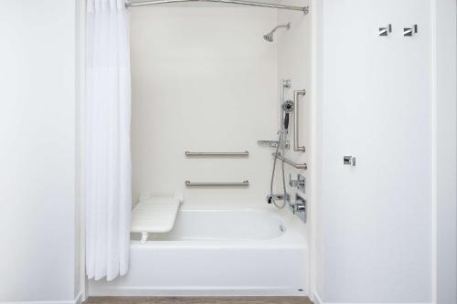 ein weißes Bad mit einer Badewanne und einer Dusche in der Unterkunft Hampton Inn & Suites San Diego Airport Liberty Station in San Diego