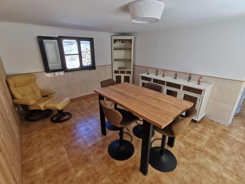 a dining room with a wooden table and chairs at Casa São Pedro Belinho ONLY PILGRIMS in Belinho