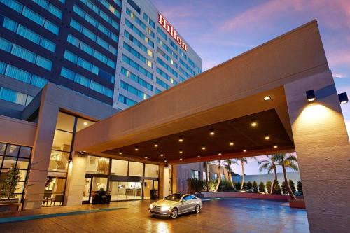 a car parked in a parking lot in front of a building at Hilton San Diego Mission Valley in San Diego