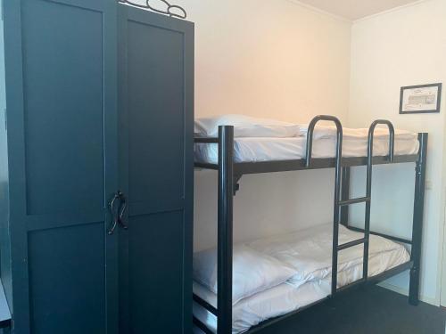 a room with two bunk beds and a door at Fletcher Strandhotel Renesse in Renesse