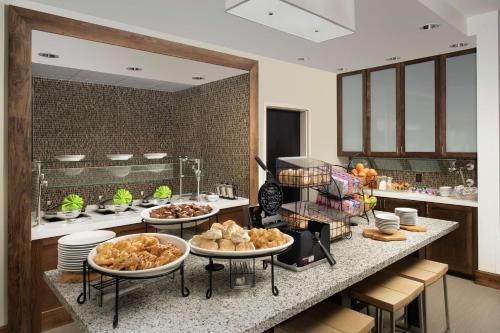 a kitchen with several plates of food on a counter at Hilton Garden Inn San Antonio Airport South in San Antonio