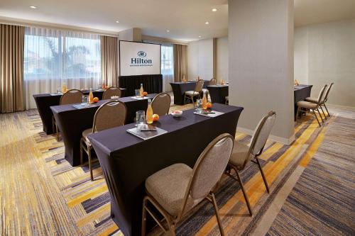 a conference room with tables and chairs and a podium at Hilton San Diego Mission Valley in San Diego
