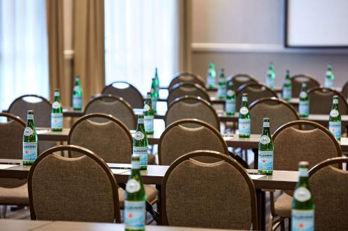 a room with tables and chairs with bottles on them at Hilton San Diego Mission Valley in San Diego
