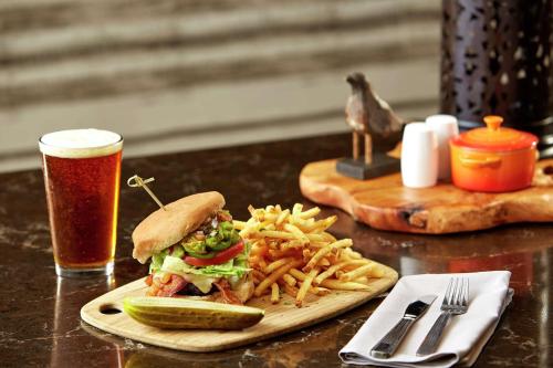 a sandwich and french fries on a table with a drink at Hilton Garden Inn San Diego Mission Valley/Stadium in San Diego