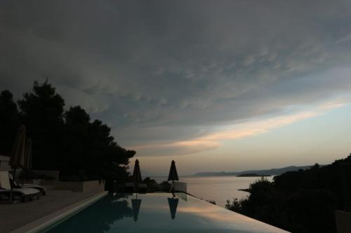 a swimming pool with a view of the water at Holiday Hvar in Vrbanj