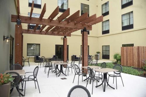 a patio with tables and chairs in front of a building at Homewood Suites by Hilton San Antonio North in San Antonio