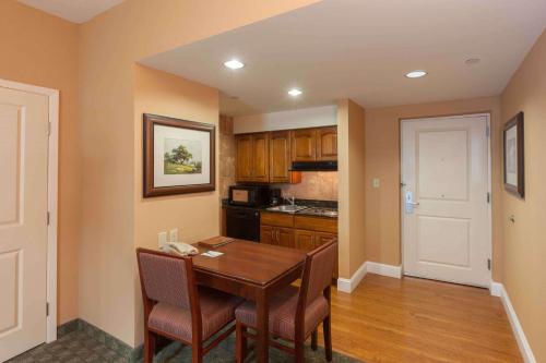 a kitchen with a table and chairs in a room at Homewood Suites by Hilton San Antonio North in San Antonio
