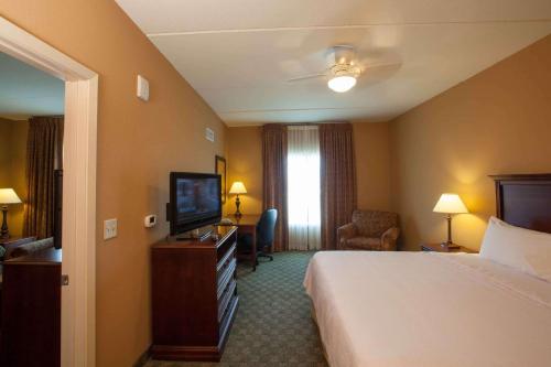 a hotel room with a bed and a television at Homewood Suites by Hilton San Antonio North in San Antonio