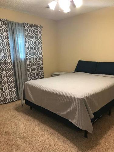 a bedroom with a large bed and a window at Terry Kuhlman in San Angelo