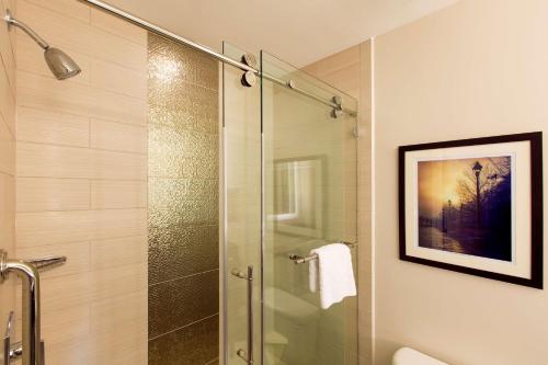 a bathroom with a shower with a glass door at DoubleTree by Hilton Historic Savannah in Savannah