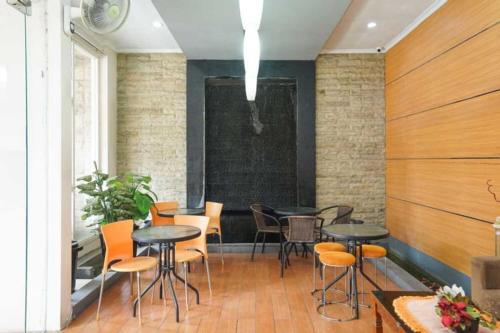 a room with tables and chairs in a building at Semampir Residence By Occupied in Surabaya