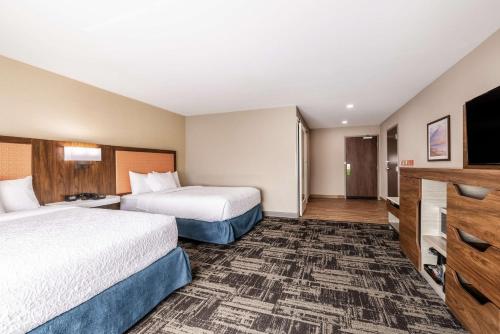 a hotel room with two beds and a flat screen tv at Hampton Inn & Suites Benton Harbor, MI in Benton Harbor