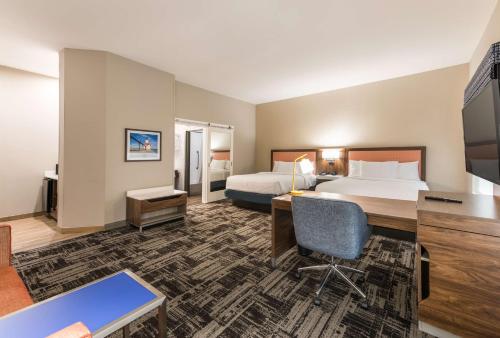 a hotel room with two beds and a desk at Hampton Inn & Suites Benton Harbor, MI in Benton Harbor