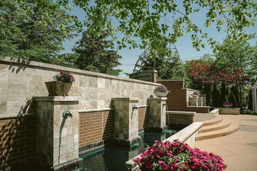 a brick retaining wall with a water fountain at Hilton Garden Inn South Bend in South Bend