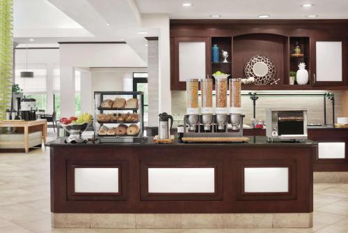 a bakery with a counter with some food on it at Hilton Garden Inn South Bend in South Bend
