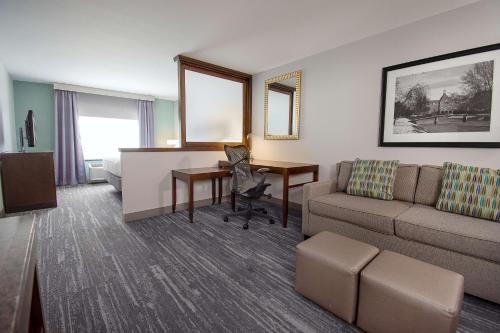 a hotel room with a couch and a desk at Hilton Garden Inn South Bend in South Bend