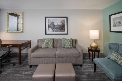 a living room with a couch and a chair at Hilton Garden Inn South Bend in South Bend