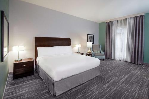 a hotel room with a bed and a window at Hilton Garden Inn South Bend in South Bend