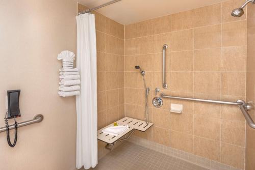 a bathroom with a shower and a toilet at DoubleTree by Hilton San Bernardino in San Bernardino