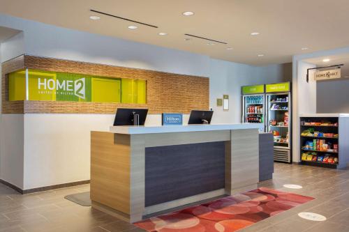 a lobby of a home store with a counter at Home2 Suites By Hilton Lewes Rehoboth Beach in Lewes