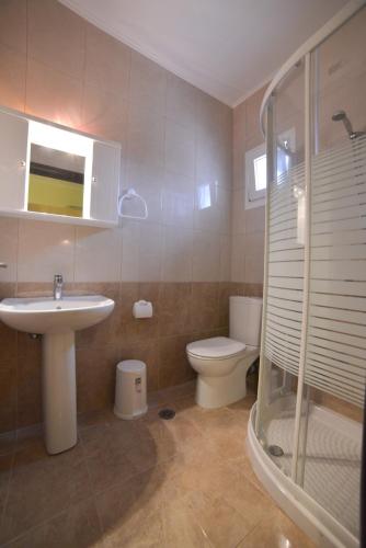 a bathroom with a sink and a toilet at Villa Agiolina in Sidari