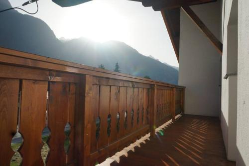 a wooden balcony with a view of a mountain at Bikers Paradise Apartment in Oberlängenfeld