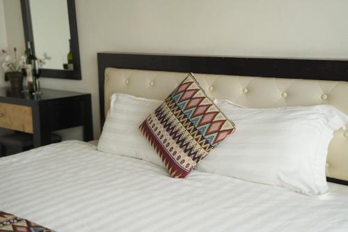 a white bed with two pillows on top of it at Phuong Nam Hotel in Sa Pa