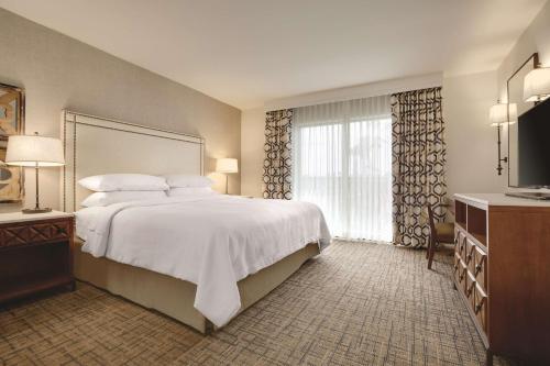 A bed or beds in a room at Embassy Suites by Hilton Scottsdale Resort