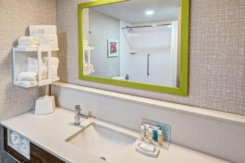 a bathroom with a sink and a mirror at Hampton Inn New Albany Louisville West in New Albany