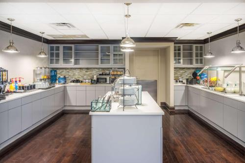 a large kitchen with white cabinets and a counter at Homewood Suites by Hilton Louisville-East in Louisville