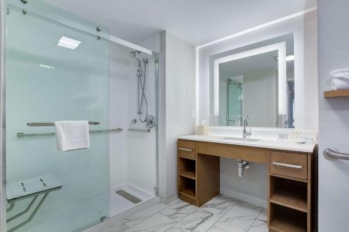 a bathroom with a shower and a sink and a mirror at Homewood Suites by Hilton Louisville-East in Louisville
