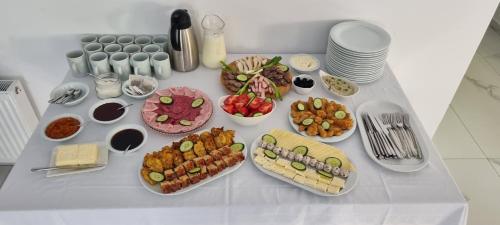 a table with many plates of food on it at Popasul Moților in Răchiţele