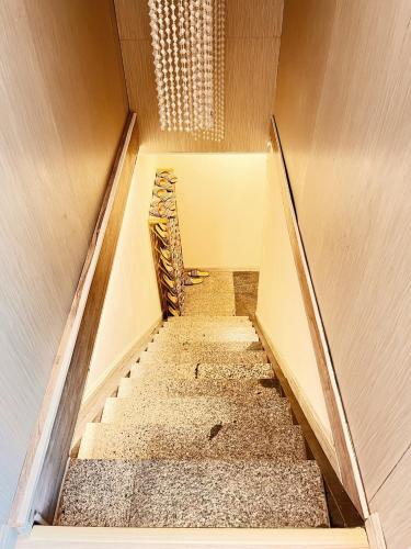 a stairwell in a room with a stair case at 20ft Sea Attic in Green Island