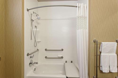 a bathroom with a shower and a white tub at Hampton Inn Seattle/Everett Downtown in Everett