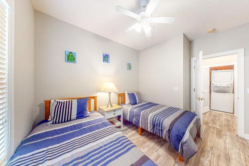 a bedroom with two beds and a ceiling fan at Barefoot Memories in North Myrtle Beach