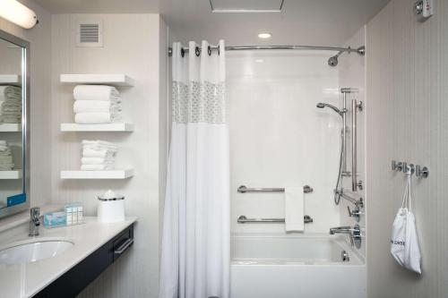 a bathroom with a shower and a sink at Hampton Inn & Suites by Hilton Seattle/Northgate in Seattle